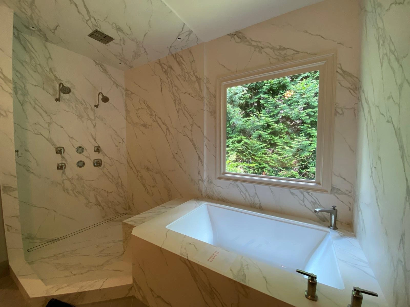 Drop-in soaking tub with full marble surround and picture window — Davie, FL