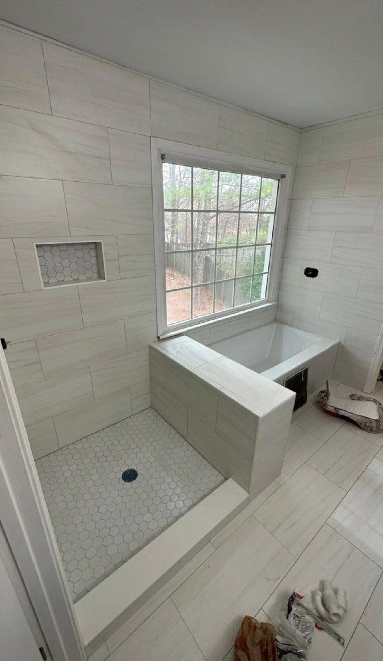 Drop-in tub with tiled surround, window and shower niche — Delray Beach, FL