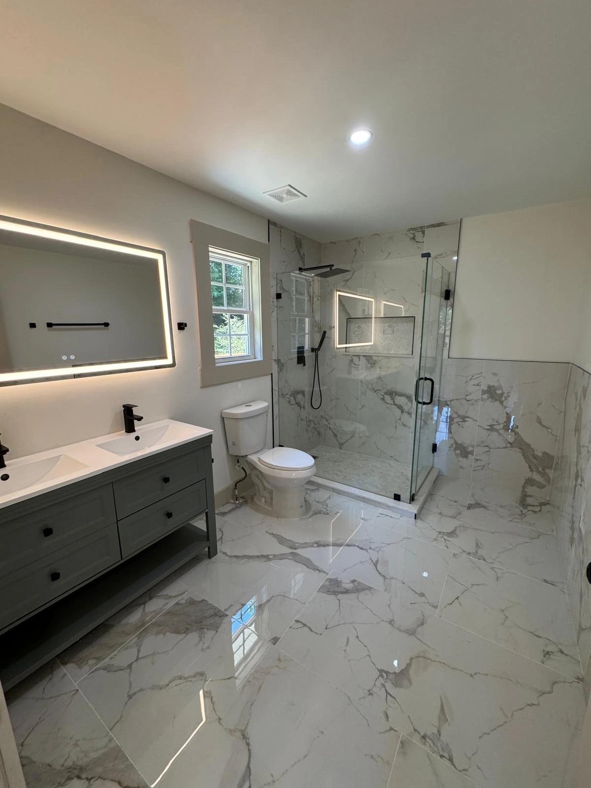 Complete bathroom remodel with backlit LED mirror, floating vanity and glass walk-in shower — Delray Beach, FL