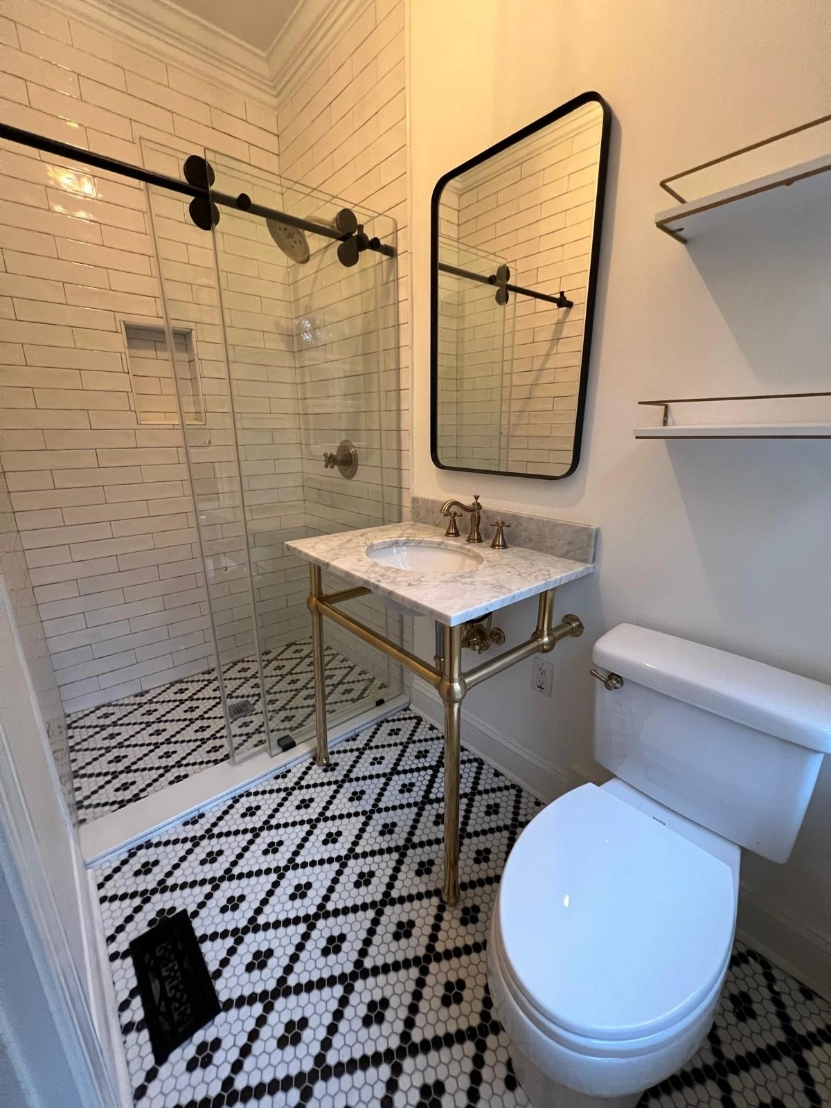 Bathroom with geometric black-and-white floor tile and pedestal sink — Davie, FL