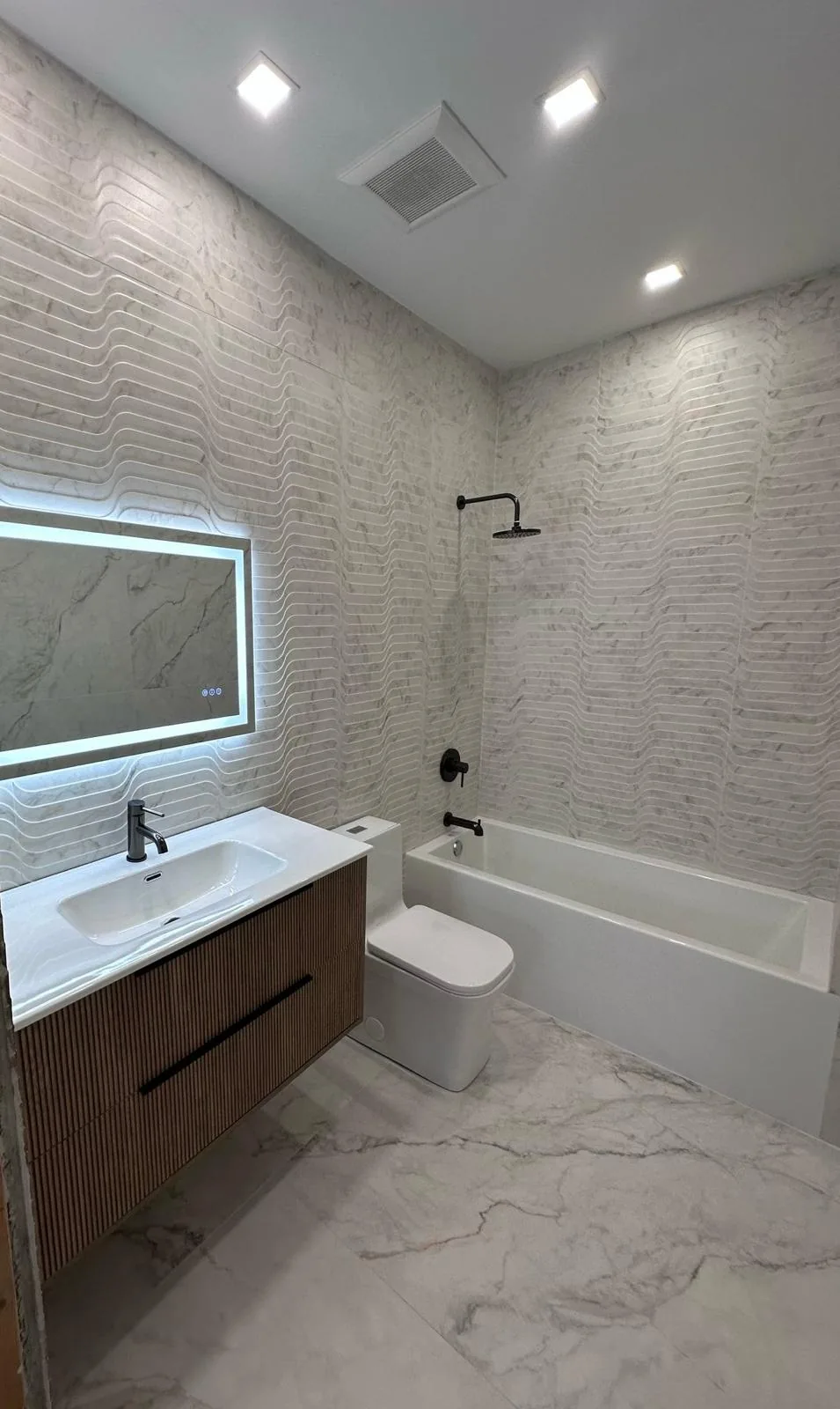 Renovated bathroom with glass shower enclosure and porcelain tile — Fort Lauderdale, FL
