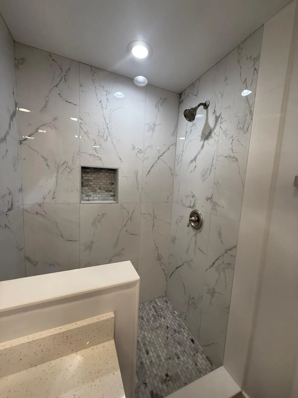 Bathroom remodel with custom tile work and modern lighting — Fort Lauderdale, FL