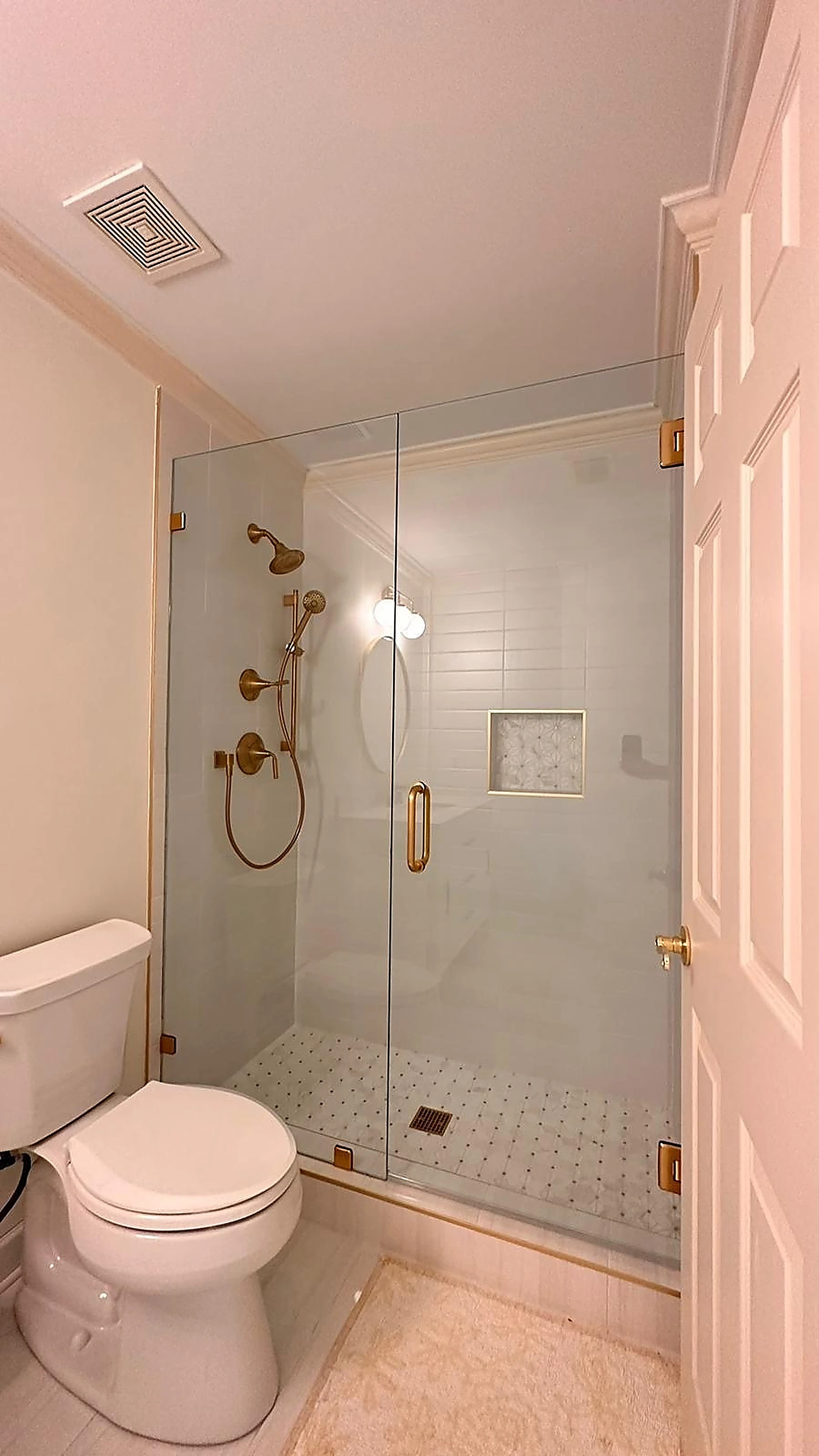 Compact glass shower with brass fixtures and marble tile — Pembroke Pines, FL