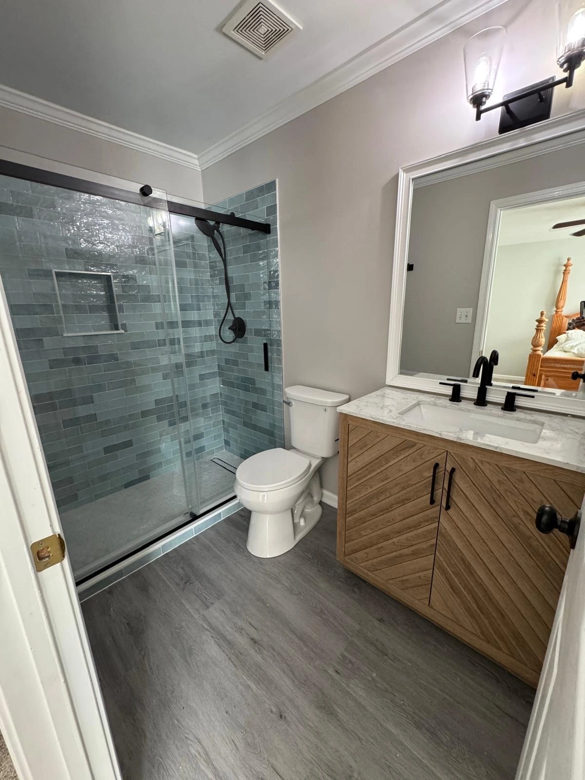 Sliding glass shower with grey tile and wood vanity — Plantation, FL