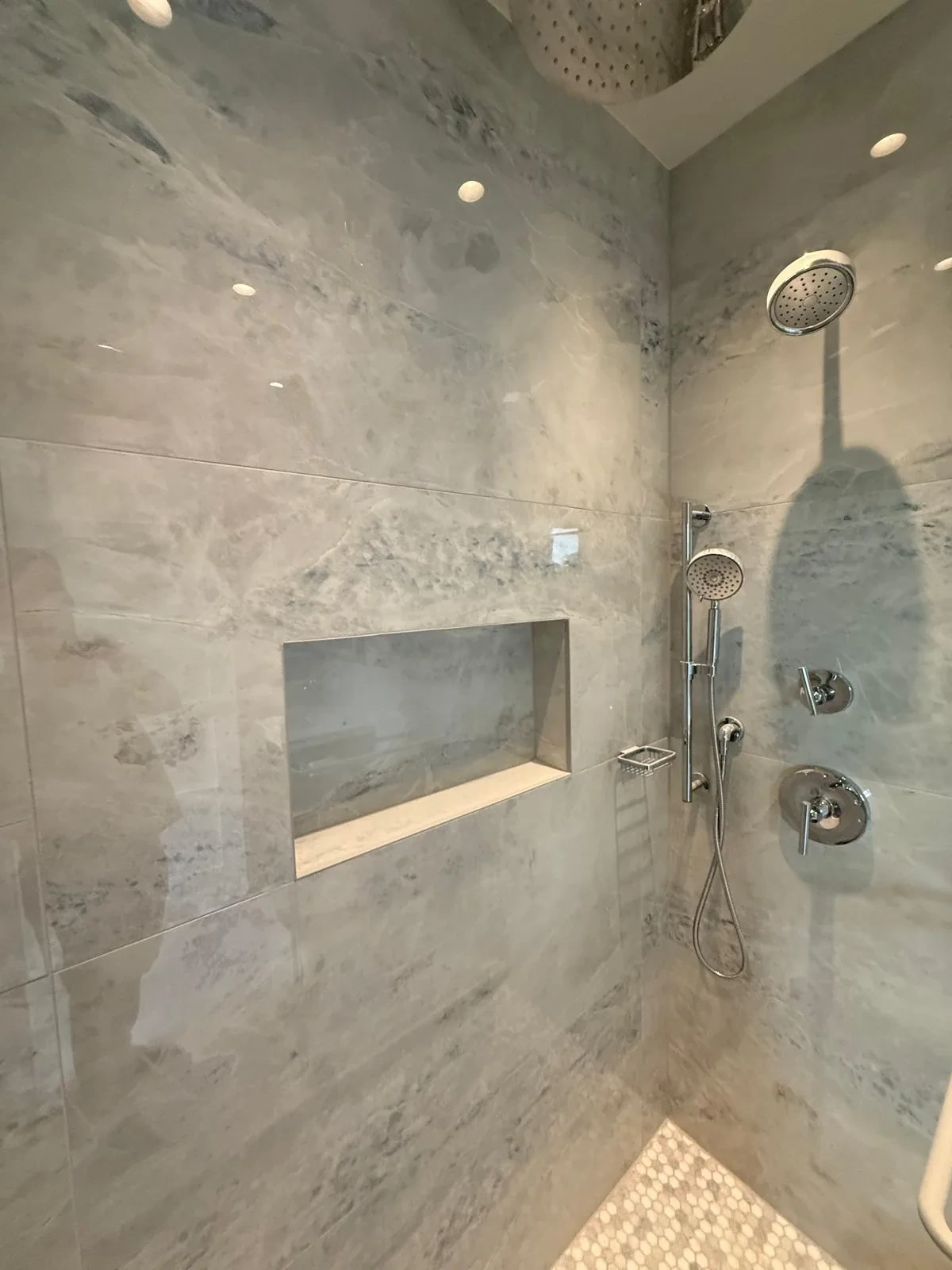 Marble walk-in shower with built-in bench