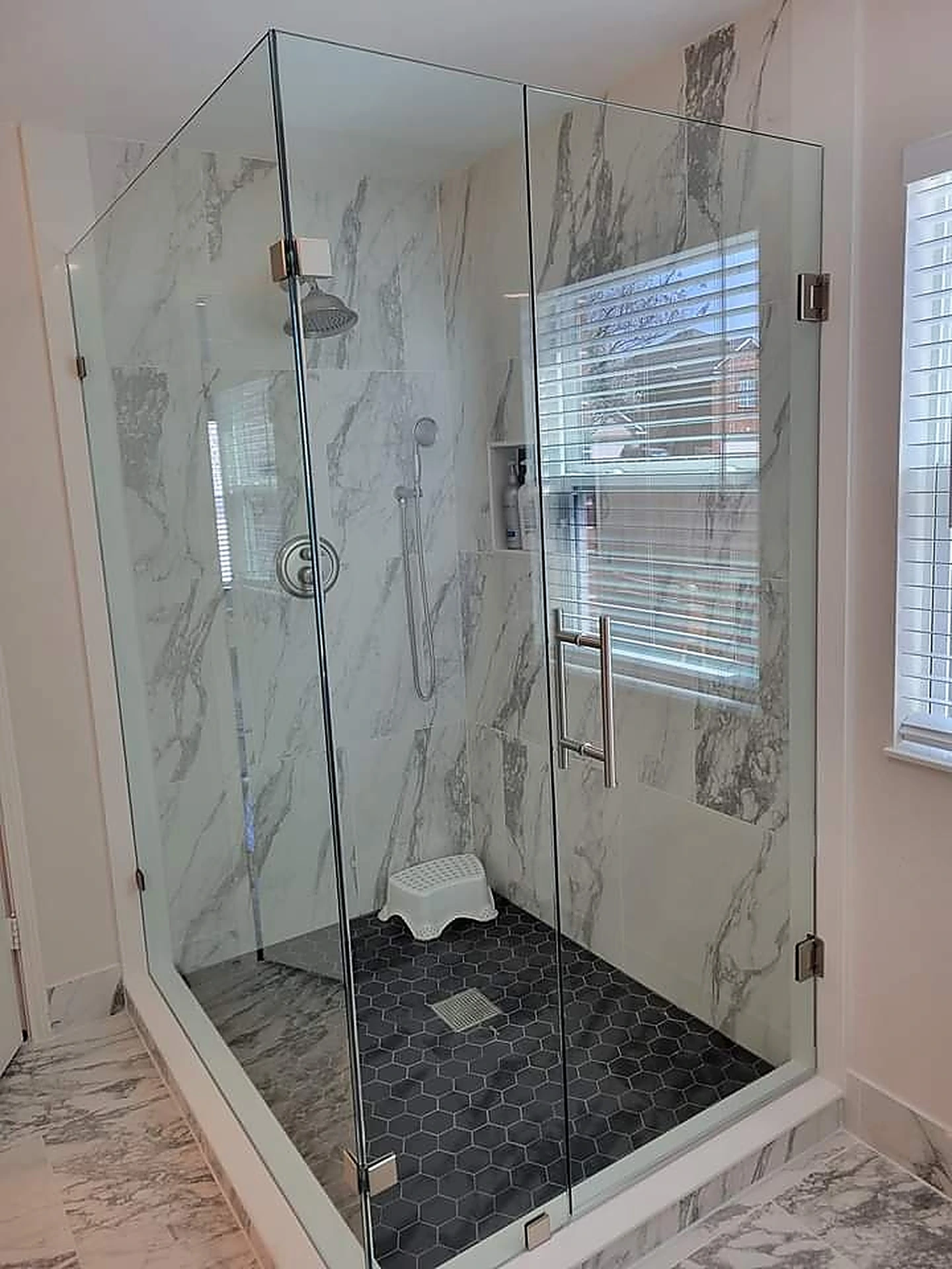 Corner glass shower with marble tile and rain shower head — Plantation, FL