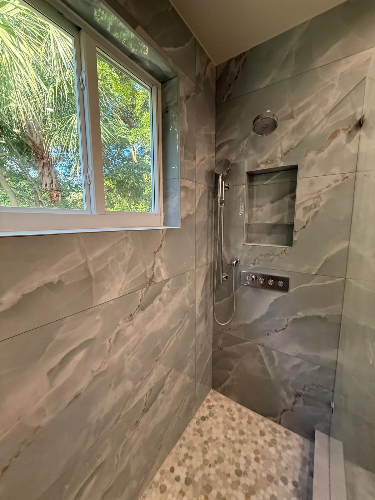 Custom tiled walk-in shower in a Hollywood FL bathroom by Primer Star Corp