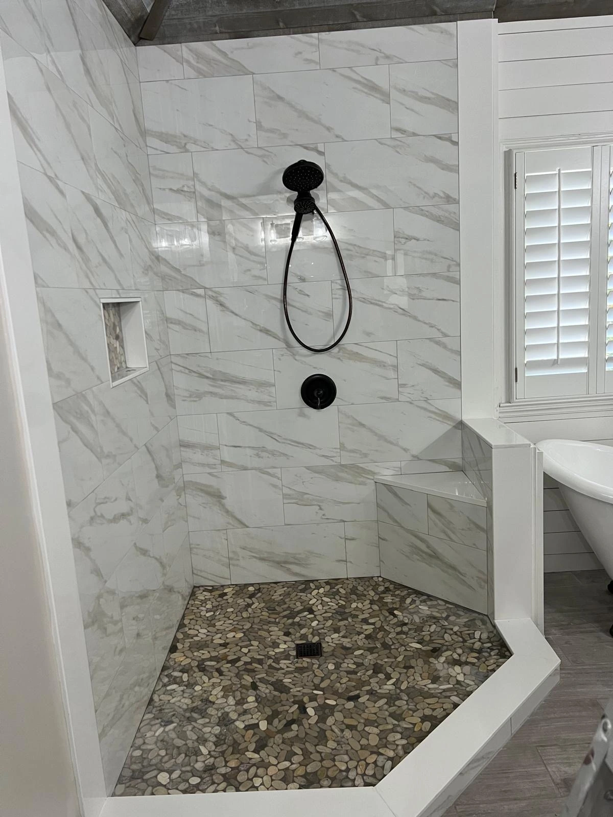 Marble walk-in shower with pebble stone shower pan — Pembroke Pines, FL