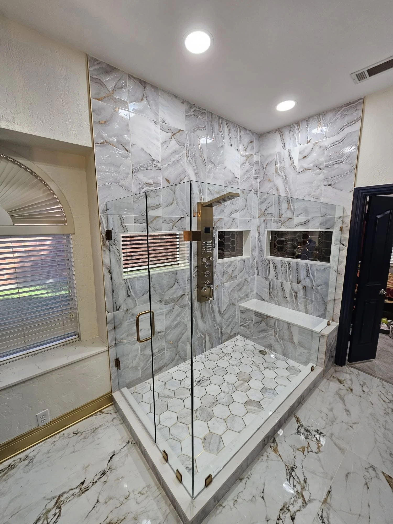Marble shower and freestanding tub with brass fixtures — Boca Raton, FL
