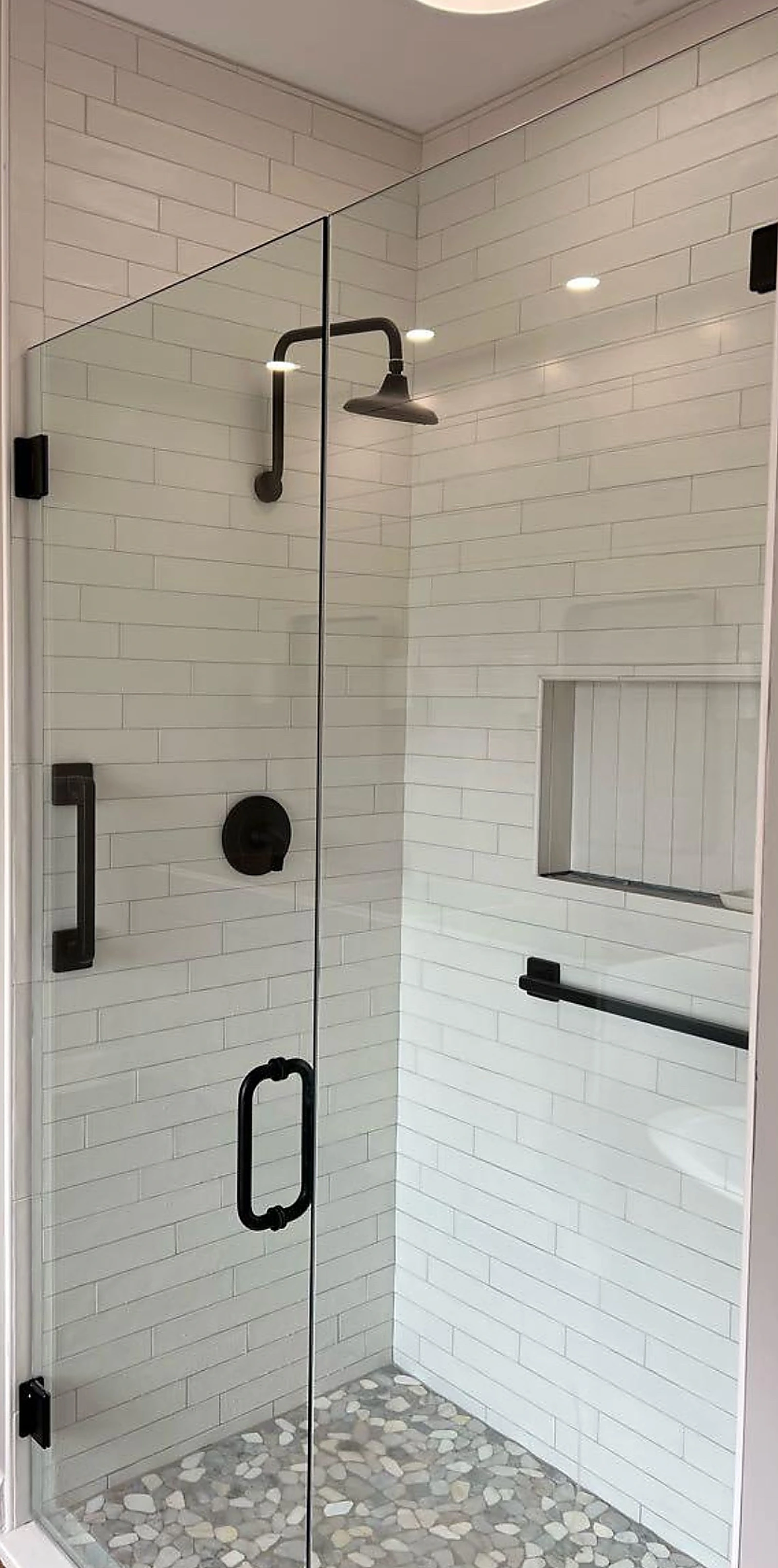Glass shower with white subway tile and black fixtures — Delray Beach, FL
