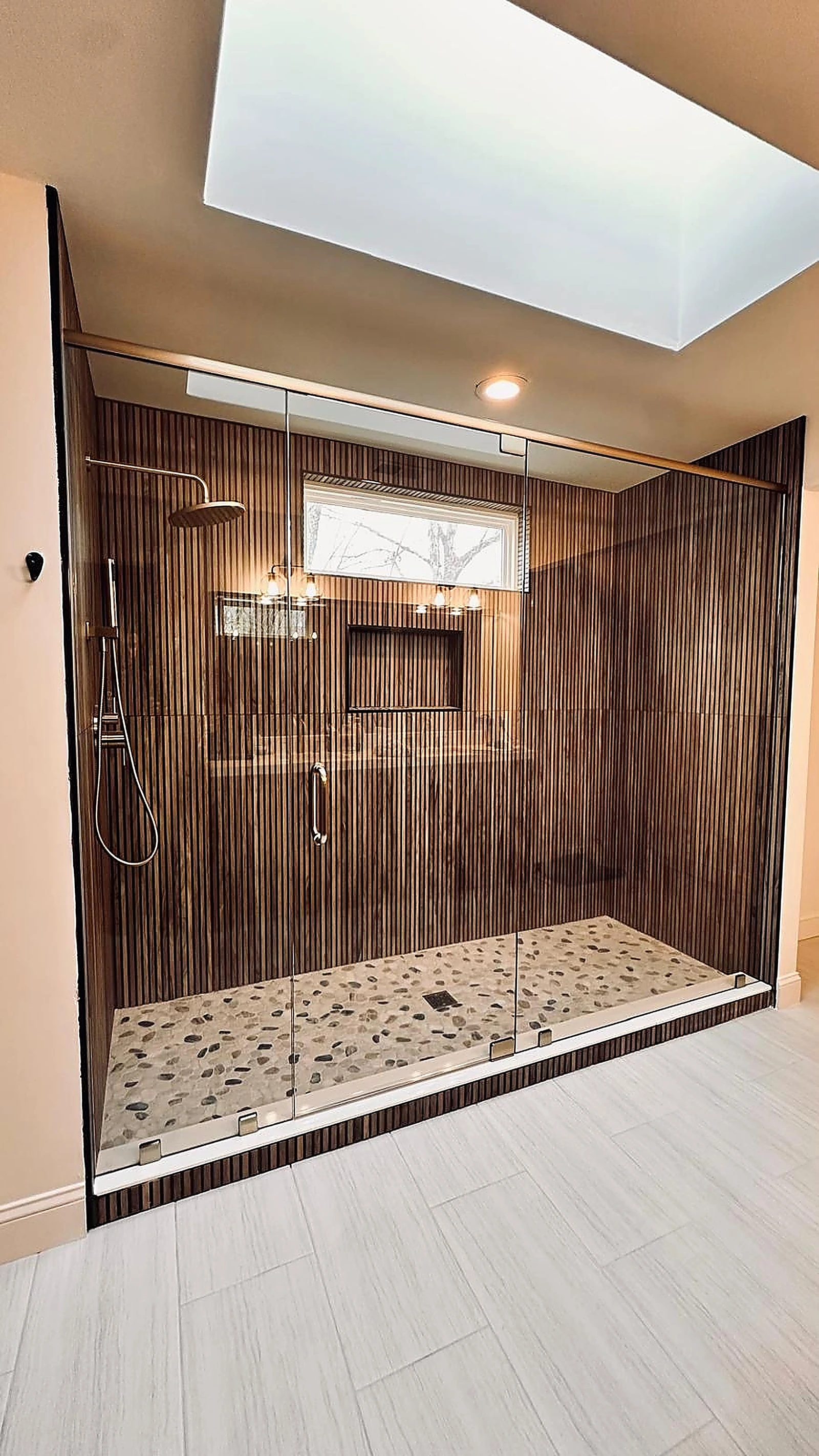 Wood-look ribbed tile shower with skylight and pebble stone shower pan — Hollywood, FL