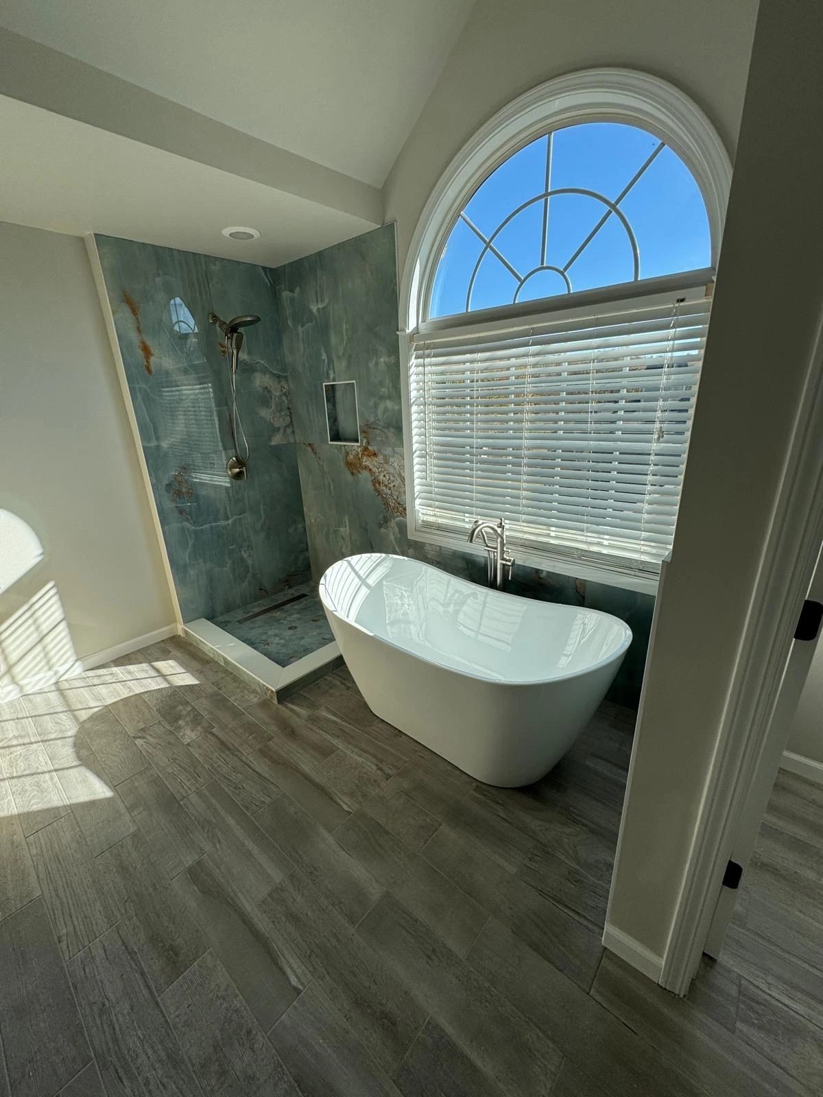Freestanding tub beside a green marble walk-in shower — Pembroke Pines, FL