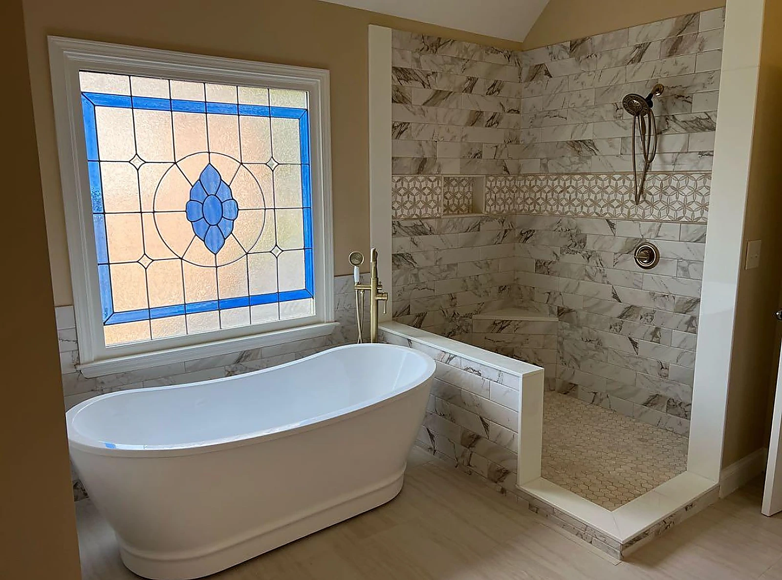 Freestanding tub beside a stained glass window and tiled shower — Delray Beach, FL