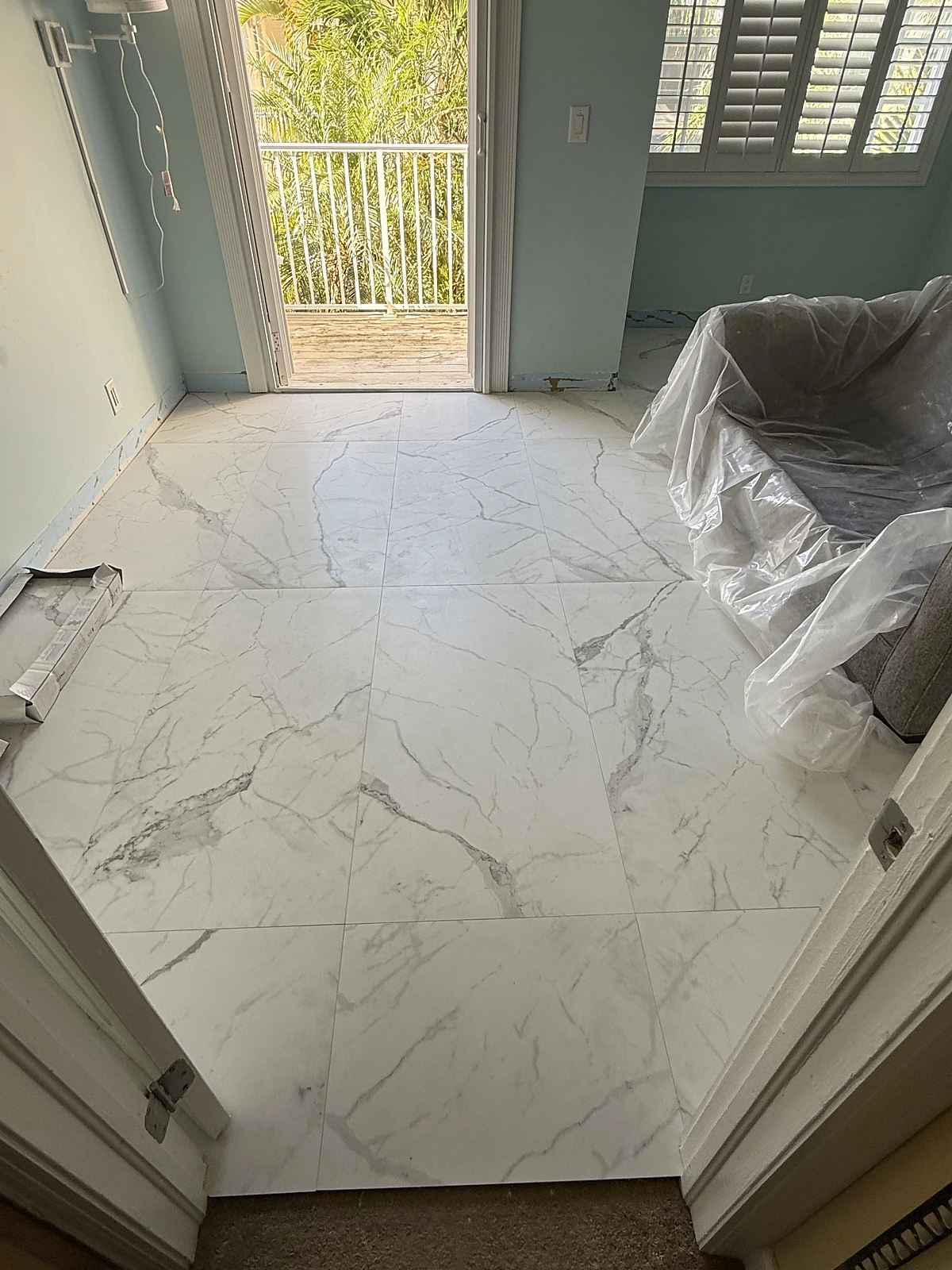 Large-format marble-look porcelain floor tile installed in a South Florida home