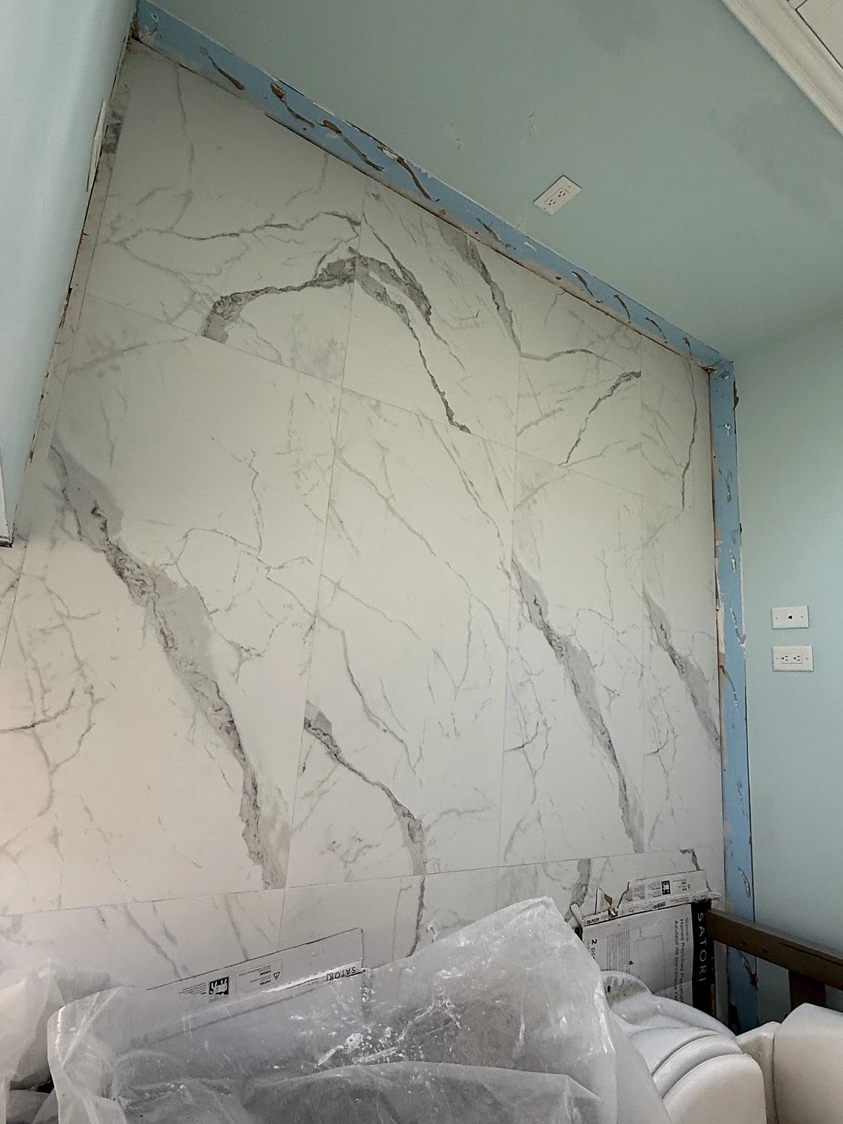Large-format Calacatta porcelain slab tile installed on a feature wall