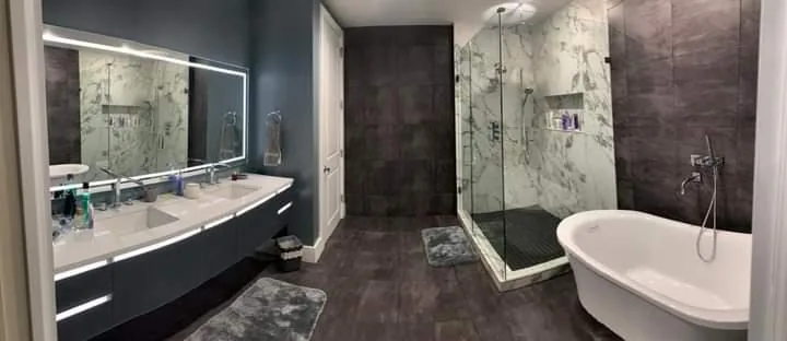 Wide master bathroom with double floating vanity and freestanding tub — Fort Lauderdale, FL