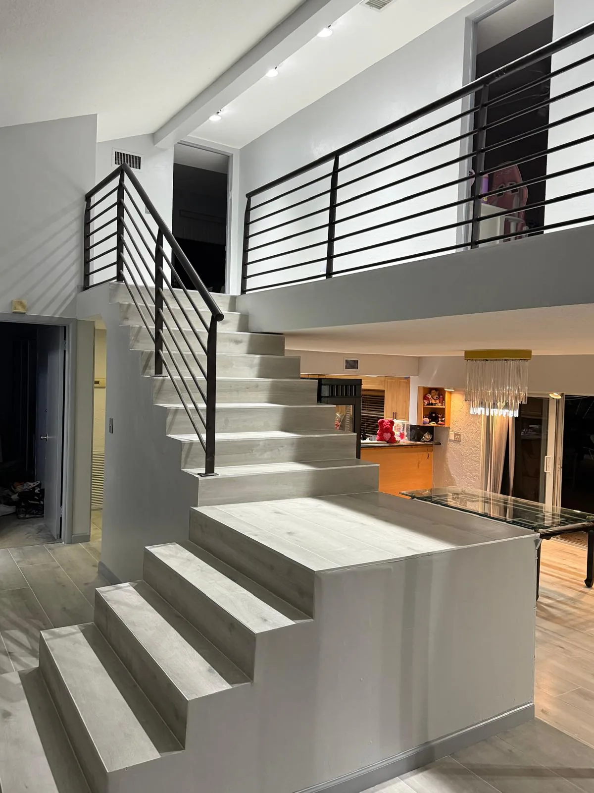 Marble-look porcelain staircase treads with black metal railing — Pembroke Pines, FL