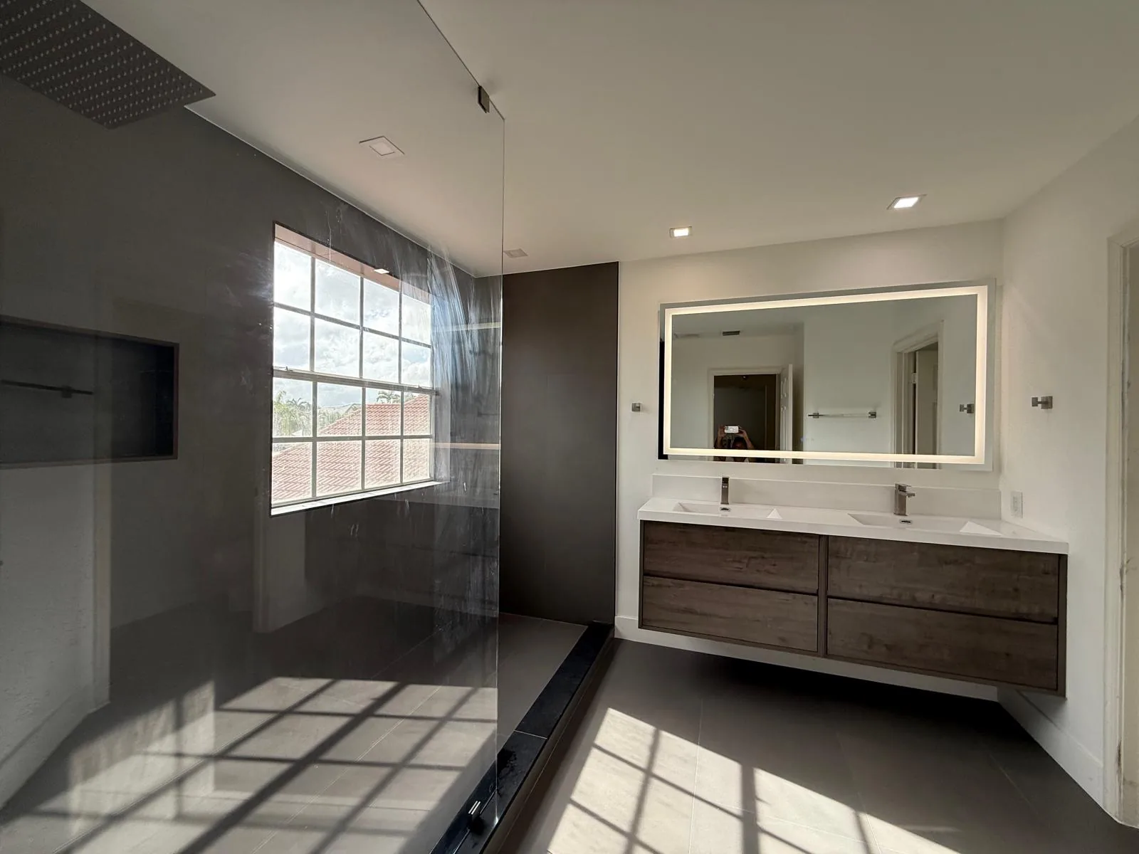 Bathroom with double floating vanity and glass block window — Fort Lauderdale, FL