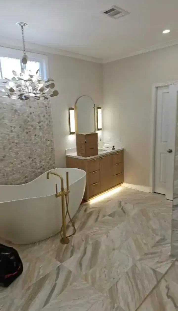 Complete luxury bathroom remodeling with freestanding tub, custom tile, and modern fixtures in South Florida home