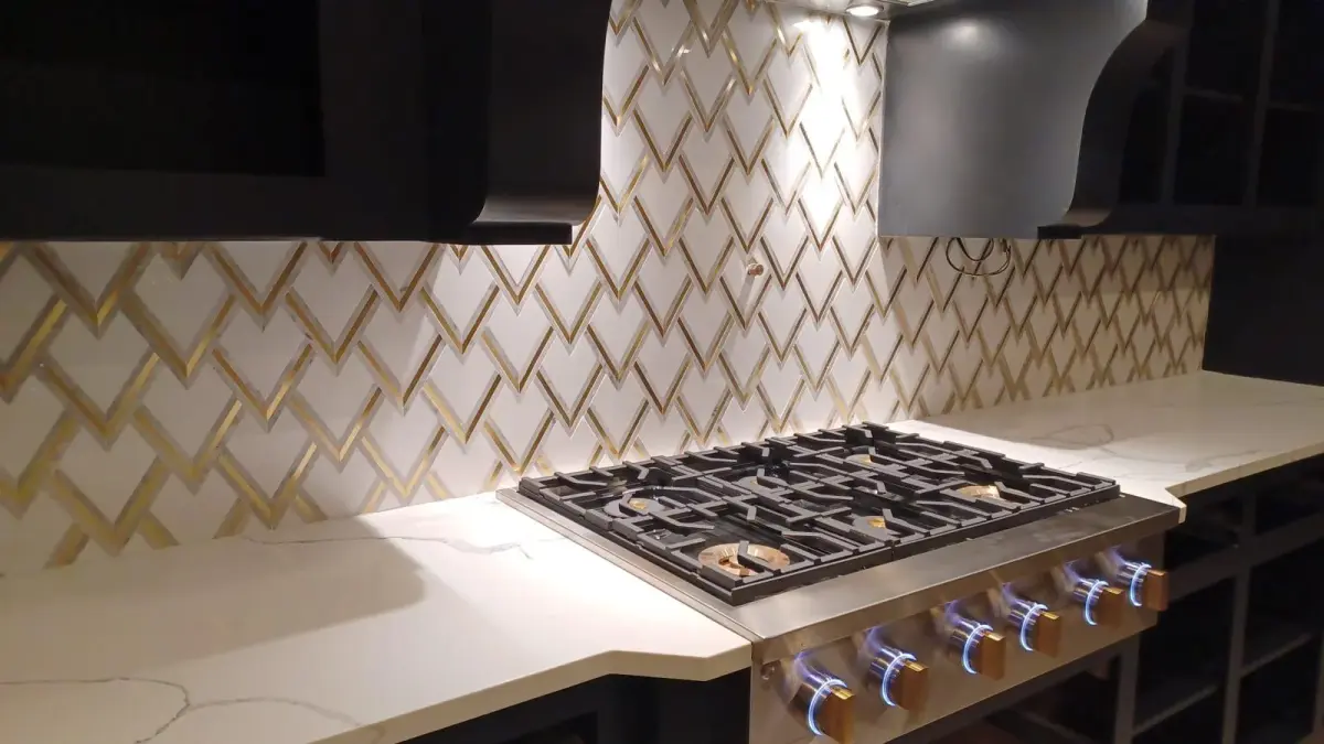 Premium gold chevron pattern backsplash with white quartz countertop in custom kitchen remodel Fort Lauderdale FL