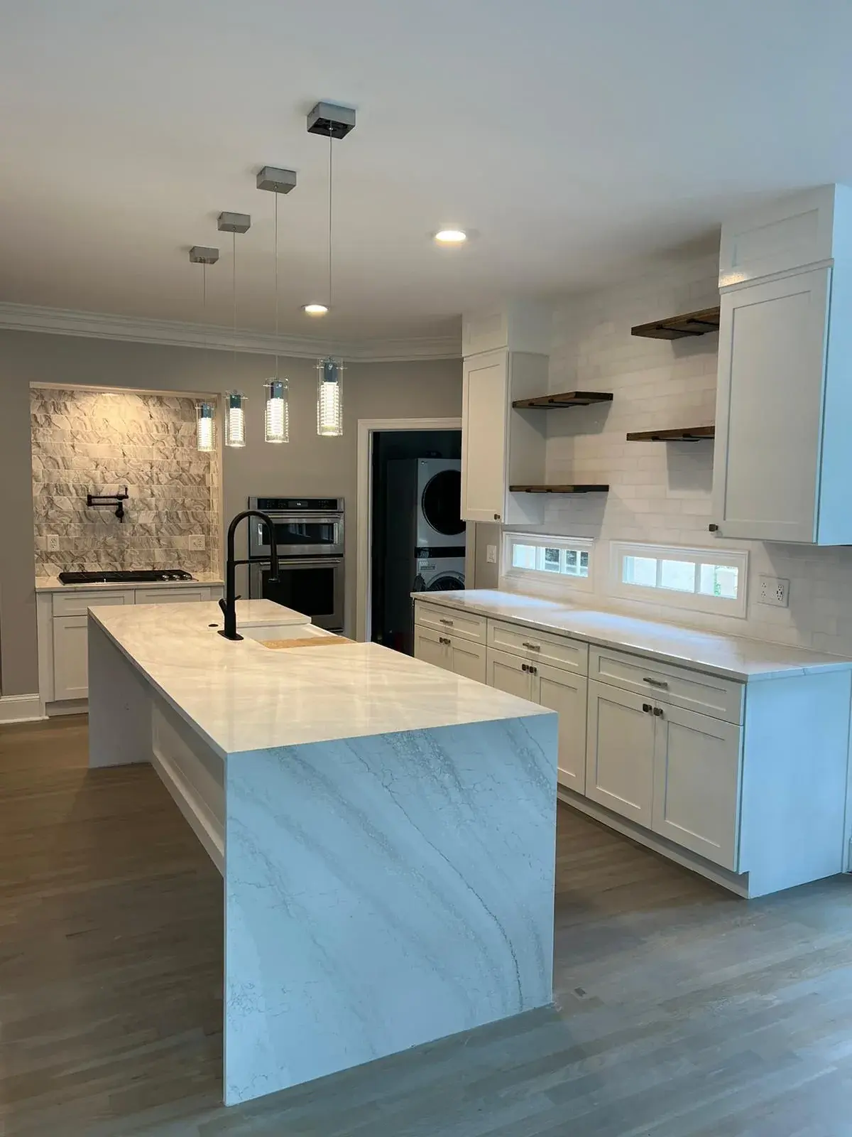 Luxury kitchen remodel with white quartz island countertop and pendant lighting in Deerfield Beach FL by Primer Star Corp